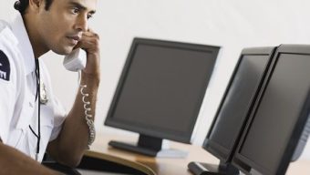 Security guard holding telephone